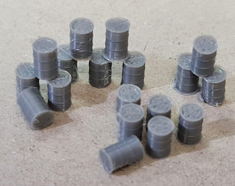 May include: A collection of small, grey, cylindrical barrel miniatures. Each barrel features a ribbed texture along the sides and a circular top with a molded design. These miniature items are arranged in a scattered formation, with some standing upright and others lying on their sides, showcasing their uniform grey color and industrial shape.