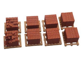 May include: Seven miniature stacks of reddish-brown rectangular bricks, each arranged on a small tan plastic pallet. The bricks are textured to resemble stacked masonry, with some stacks appearing uniform and others showing irregular brick placement.