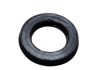 May include: A circular black washer with a textured, ridged surface pattern on its top face. The object features a smooth outer edge and a central circular opening, displaying a dark, matte finish with visible fine lines across the top surface.