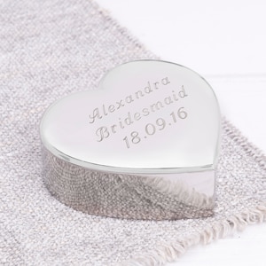 May include: A silver heart-shaped trinket box with the inscription "Alexandra Bridesmaid 18.09.16".
