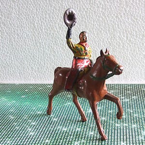 Vintage John Hill Mounted Cowboy waving his hat