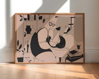 May include: A framed horizontal art print featuring a stylized illustration in black and muted pink. The drawing depicts a figure wearing glasses and a dark tank top, sitting and interacting with a black cat. Shelves with vases, plants, and books are visible.