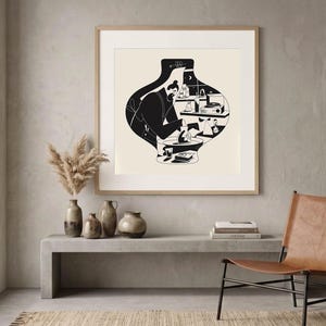 May include: A square framed wall art print featuring a black and white illustration of a person working at a pottery wheel inside a large vase-shaped outline. The scene includes shelves with various objects, a crescent moon, and a small star.