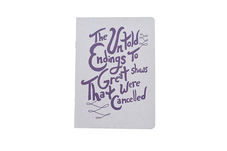 May include: A gray notebook with a purple inscription that reads "The Untold Endings To Great Shows That Were Cancelled".