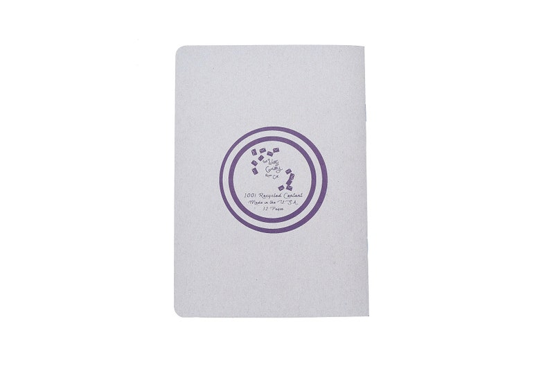 May include: A white notebook with a purple circle logo that says "The Ugly  Grocery Co.". The circle also says "100% Recycled Content, Made in the U.S.A., 32  Pages".