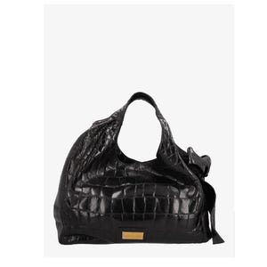 May include: Black leather shoulder bag with a crocodile skin texture. The bag has a large, open design with a single shoulder strap. A small, rectangular gold-colored plaque is on the front.