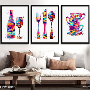 May include: Set of three colorful abstract art prints featuring a wine bottle and glass, a fork, knife, and spoon, and a stack of teacups. The prints are framed in black and displayed on a white wall.