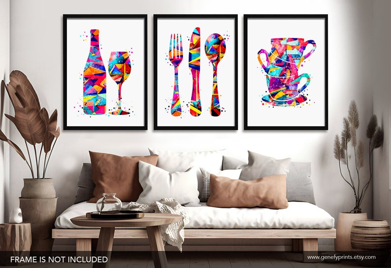 May include: Set of three colorful abstract art prints featuring a wine bottle and glass, a fork, knife, and spoon, and a stack of teacups. The prints are framed in black and displayed on a white wall.