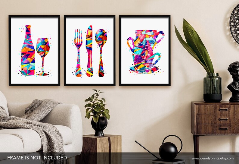 May include: Set of three colorful abstract watercolor prints featuring a wine bottle and glass, a fork, knife, and spoon, and a stack of teacups. The prints are framed in black frames.