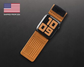 May include: A brown leather Apple Watch band with a velcro closure and an American flag embossed on the strap. The watch face displays the time as 10:09.