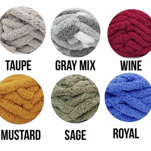 May include: Six balls of yarn in different colors: taupe, gray mix, wine, mustard, sage, and royal blue. The yarn is chunky and fluffy, perfect for crocheting or knitting.