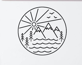 May include: A circular black line art decal applied to the white rear door of a van. The design features a sun with radiating lines, three mountain peaks, a forest of pine trees, wavy water lines, and three small birds flying in the sky.