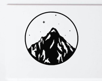 May include: A black circular vinyl decal featuring a stylized mountain peak silhouette with white snow accents and small four-pointed stars scattered within the upper portion of the circle, applied to the white rear panel of a vehicle.