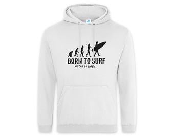 May include: A white hooded sweatshirt featuring a black graphic of human evolution ending with a surfer carrying a surfboard. Below the graphic, the text reads BORN TO SURF forced to work in a black, distressed, sans-serif font.
