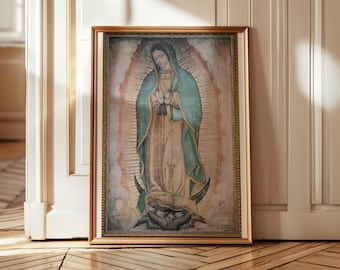May include: A framed print of Our Lady of Guadalupe. The artwork depicts a woman in a teal cloak and a cream-colored dress, surrounded by a golden halo. The frame is gold, and the image is set against a light background.