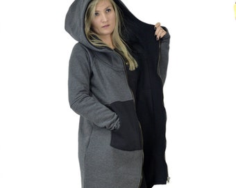 May include: A long gray and black hooded sweatshirt with a zipper closure. The sweatshirt has a large pocket on the front and a high neckline.