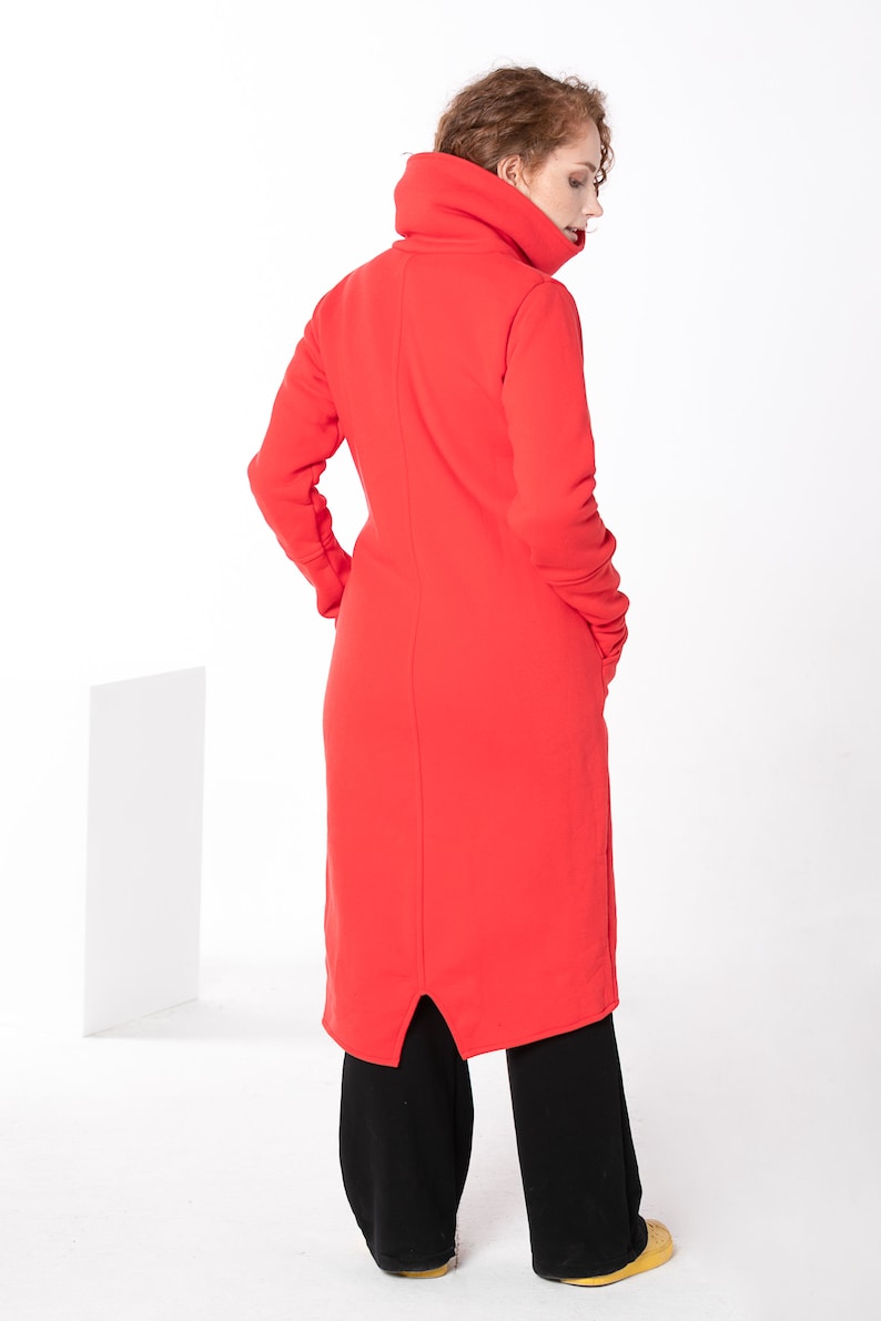 May include: A long red dress with a high, folded collar and a slit in the back. The dress is made of a soft, comfortable fabric.