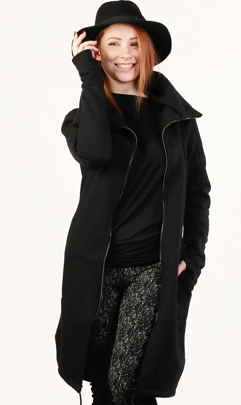 May include: A black long-sleeved jacket with a zipper closure and a high collar. The jacket has a relaxed fit and is made of a soft, comfortable fabric.