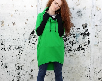 May include: A green hooded sweatshirt with black sleeves and a long, asymmetrical hemline. The sweatshirt has a drawstring hood and a kangaroo pocket.