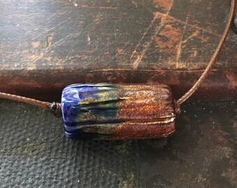 Barrel Shaped Ceramic Focal Pendant. The glazes give off a shimmer and it's reversible.