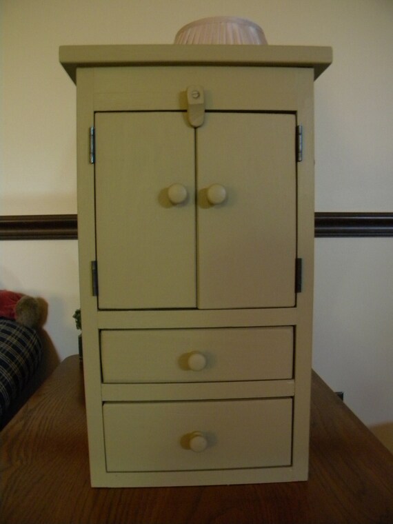 A Wooden Off White In Color Wall Hanging Cabinet With Two Door And Two Drawers Made In The Usa