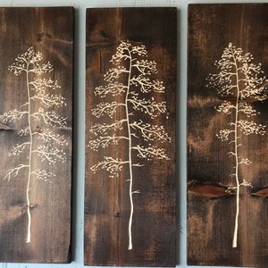 3 large hand carved trees