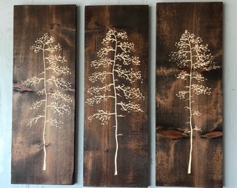 3 large hand carved trees