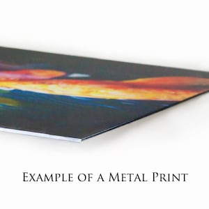 May include: A close-up of a metal print with a colorful abstract design. The print has a glossy finish and is mounted on a metal base.