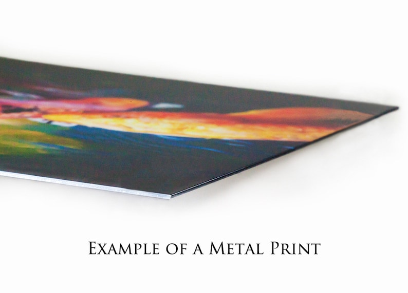 May include: A close-up of a metal print with a colorful abstract design. The print has a glossy finish and is mounted on a metal base.