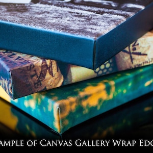 May include: Close-up of the edges of three canvas prints, showing how the image wraps around the sides. The top print has a blue border, the middle print has a cork and floral design, and the bottom print has a green and yellow design.