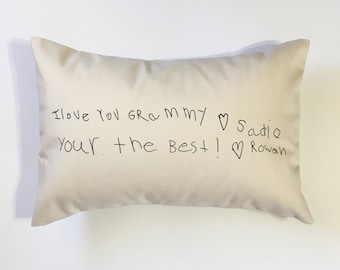 May include: A white pillow with black handwritten text that reads "I love you Grammy ♥ Sadie Your the best! ♥ Rowan"