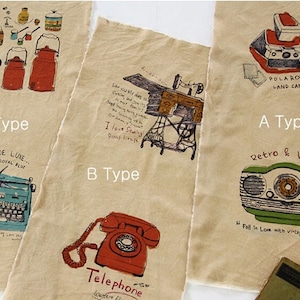 May include: Three fabric swatches with different vintage-inspired illustrations. The first swatch features a Polaroid camera, a radio, and the text "Retro & Vintage". The second swatch features a sewing machine, a telephone, and the text "I love Sewing". The third swatch features a typewriter, a coffee pot, and the text "Quiet de Luxe... Royal Blue".
