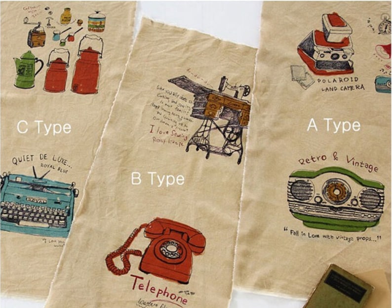 May include: Three fabric swatches with different vintage-inspired illustrations. The first swatch features a Polaroid camera, a radio, and the text "Retro & Vintage". The second swatch features a sewing machine, a telephone, and the text "I love Sewing". The third swatch features a typewriter, a coffee pot, and the text "Quiet de Luxe... Royal Blue".