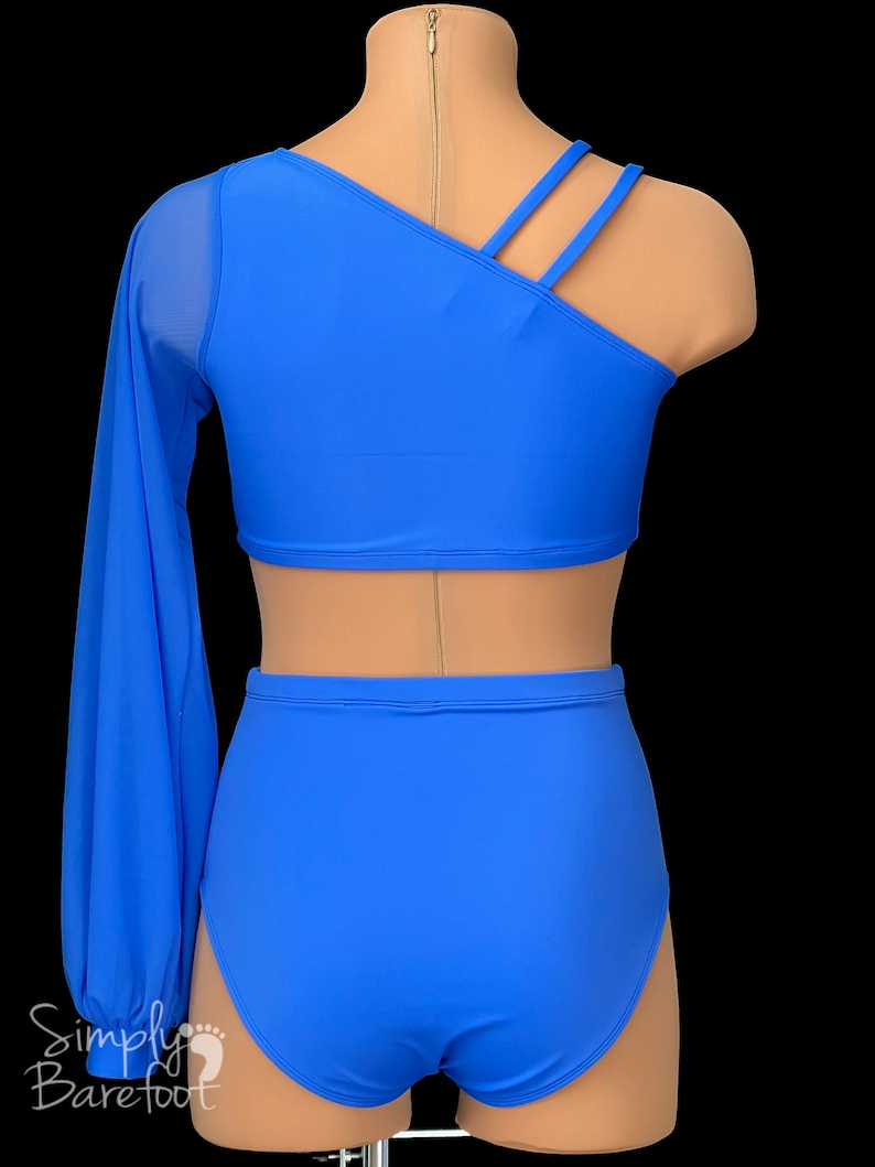 May include: A blue dance costume with a one-shoulder top and long sleeve, and high-waisted shorts. The top has a diagonal neckline and three straps across the back.