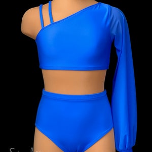 May include: A blue dance outfit with a one-shoulder crop top and high-waisted bottoms. The top has a long sleeve on one arm, made of sheer fabric. The outfit is on a mannequin.