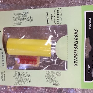Case of 12 Adams Magic Tricks Pranks & Puzzles Shooting Lighter NOS Yellow or Red