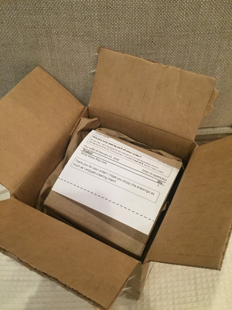 May include: A white glossy mug with the text "Thank you for your order! I hope you enjoy the drawings as much as I enjoyed creating them!" printed on a white paper inside a brown cardboard box.