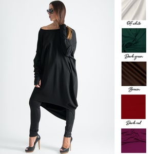May include: A black long-sleeved tunic with a loose fit and a high, round neckline. The tunic is paired with black leggings and black high-heeled shoes.