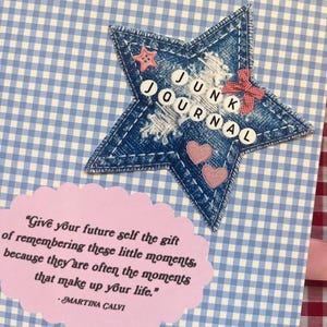 May include: A handmade junk journal cover with a denim star, featuring the words "JUNK JOURNAL". The star is adorned with a red bow, pink hearts, and a pink star. A pink oval with a quote is below.