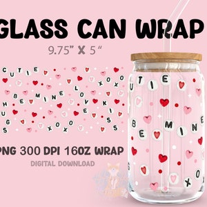May include: A glass can wrap with a pink background and white polka dots. The wrap features red hearts and white letters spelling out "cutie", "be mine", "love", "hugs", and "kiss". The can is 9.75 inches by 5 inches.
