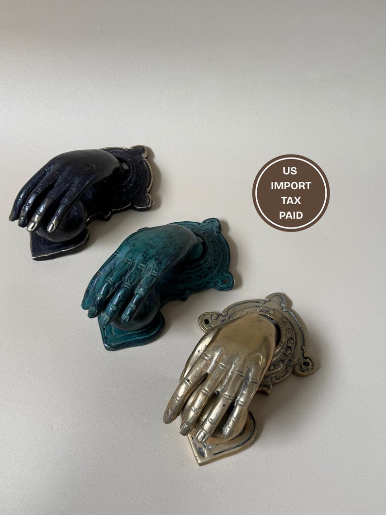 May include: Three decorative hand-shaped door knockers in black, teal, and gold. Each knocker features a detailed hand design with a decorative backplate. The knockers are made of metal and have a vintage aesthetic.