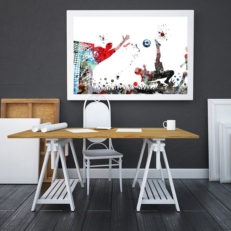 Puede incluir: Una pintura de acuarela de dos jugadores de f&uacute;tbol en acci&oacute;n. Un jugador est&aacute; pateando el bal&oacute;n mientras que el otro jugador se lanza para bloquear el tiro. La pintura est&aacute; sobre un fondo blanco con salpicaduras de color.