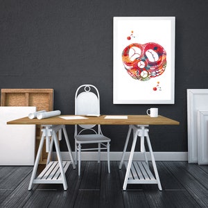 May include: A watercolor painting of a human heart, with red, orange, and yellow colors, framed and hanging on a white wall above a wooden table with a white chair and a white mug.