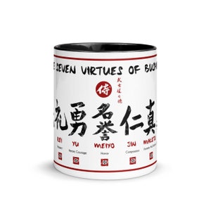 May include: White ceramic mug with a black rim and handle. The mug features black calligraphy in Japanese characters with the text "Seven Virtues of Bushido" and the English translations of the characters below. The characters are "Rei", "Yu", "Meiyo", "Jin", and "Makoto".