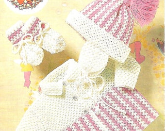 May include: A crocheted baby outfit set in white and pink. The set includes a hat, a cardigan, and booties. The hat has a pink pom-pom on top. The cardigan has a white collar and a pink and white striped pattern on the bottom half. The booties have a pink and white striped pattern.