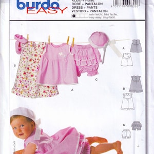 May include: Burda Easy sewing pattern number 9802 for a baby dress and bloomers. The pattern includes instructions for making a pink dress with a butterfly design, a pink ruffled bloomer, and a white hat. The pattern is very easy to follow and includes seam and hem allowances.