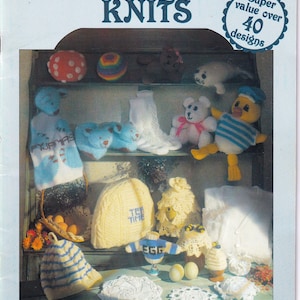 May include: A book cover with the title "Hayfield Novelty Knits" and a picture of various knitted items, including a tea cozy, a baby bootie, a doll, and a hat. The book cover also includes the text "Super value over 40 designs".