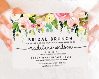 May include: Bridal brunch invitation with a watercolor floral design. The invitation is for Madeline Watson on July 28, 2017, at Cocoa Bean Cupcake House, 123 Main Street, Preston, ID, 83440. RSVP to Megan at 201-545-1122. Registered at Target.