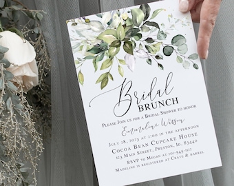 Może przedstawiać: Białe zaproszenie na wieczór panieński z zielonymi akwarelowymi liśćmi i tekstem "Bridal Brunch" w czarnym, ozdobnym piśmie. Zaproszenie jest na wieczór panieński dla "Emmeline Wilson" 28 lipca 2023 roku o godzinie 14:00 w Cocoa Bean Cupcake House. Adres to 123 Main Street, Preston, ID. 83440. Prosimy o potwierdzenie uczestnictwa do Megan pod numerem 201-545-1822. Madeline jest zarejestrowana w Crate & Barrel.