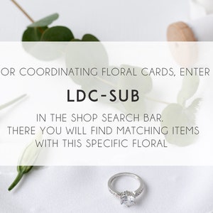 May include: A white background with a silver ring and green leaves. Text reads: "FOR COORDINATING FLORAL CARDS, ENTER LDC-SUB IN THE SHOP SEARCH BAR. THERE YOU WILL FIND MATCHING ITEMS WITH THIS SPECIFIC FLORAL"